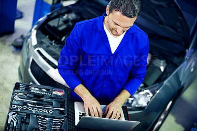 Buy stock photo Man, laptop and car mechanic in workshop with tools, typing quote and cost of maintenance service. Above, person and technician in small business with computer, fix vehicle and report repair expenses