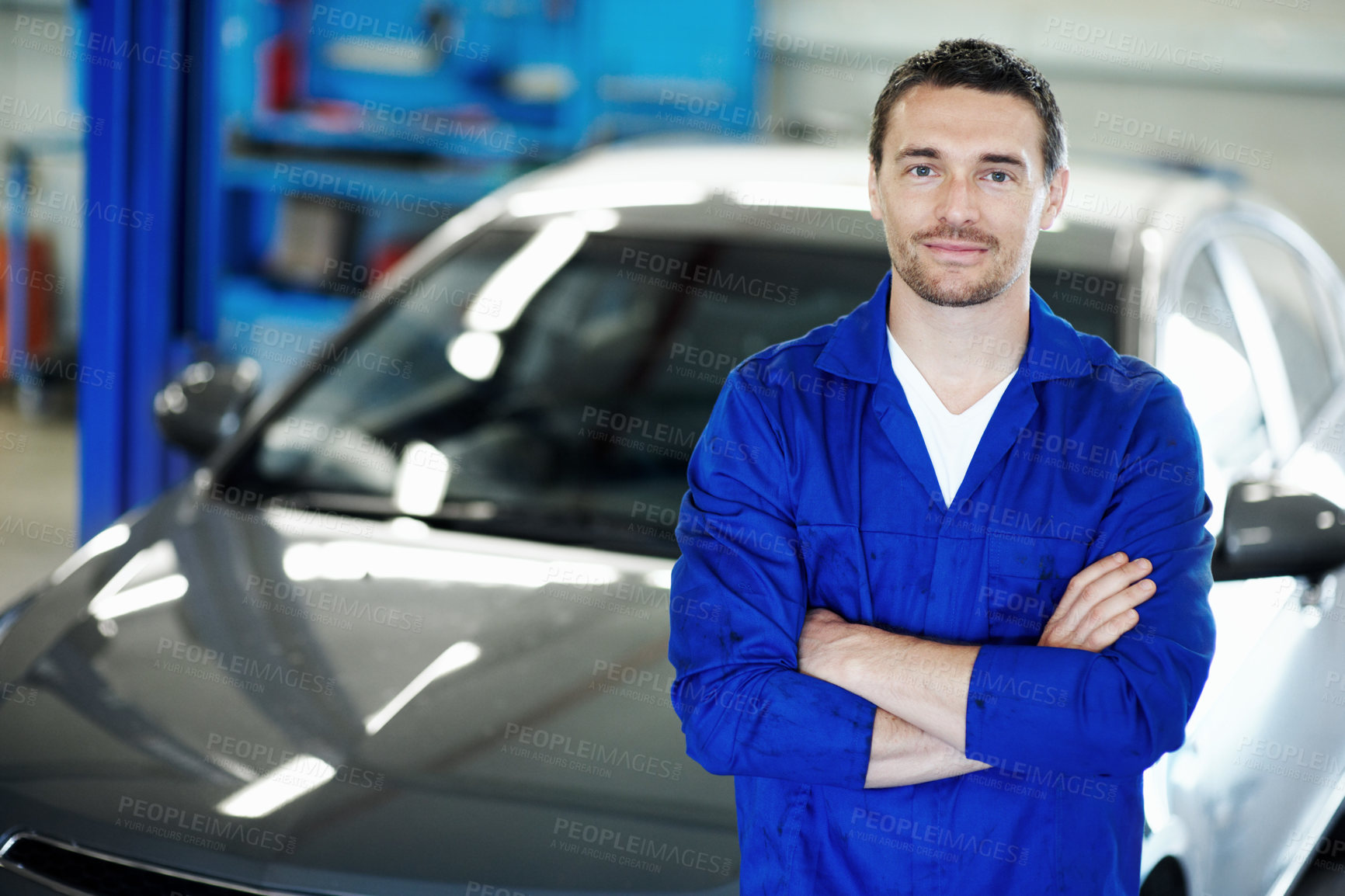 Buy stock photo Man, mechanic and arms crossed with car at workshop in portrait for job, inspection or repair service. Person, technician or engineer with vehicle, confidence or career for maintenance in auto garage