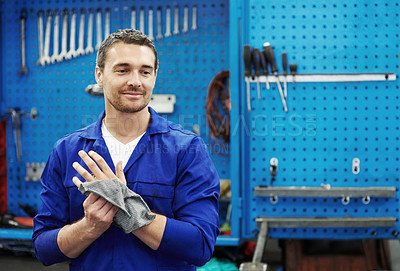Buy stock photo Man, mechanic and cloth for hands at garage in portrait for hygiene, inspection or repair service. Person, technician or engineer with vehicle, confidence or rag for oil with career in auto workshop