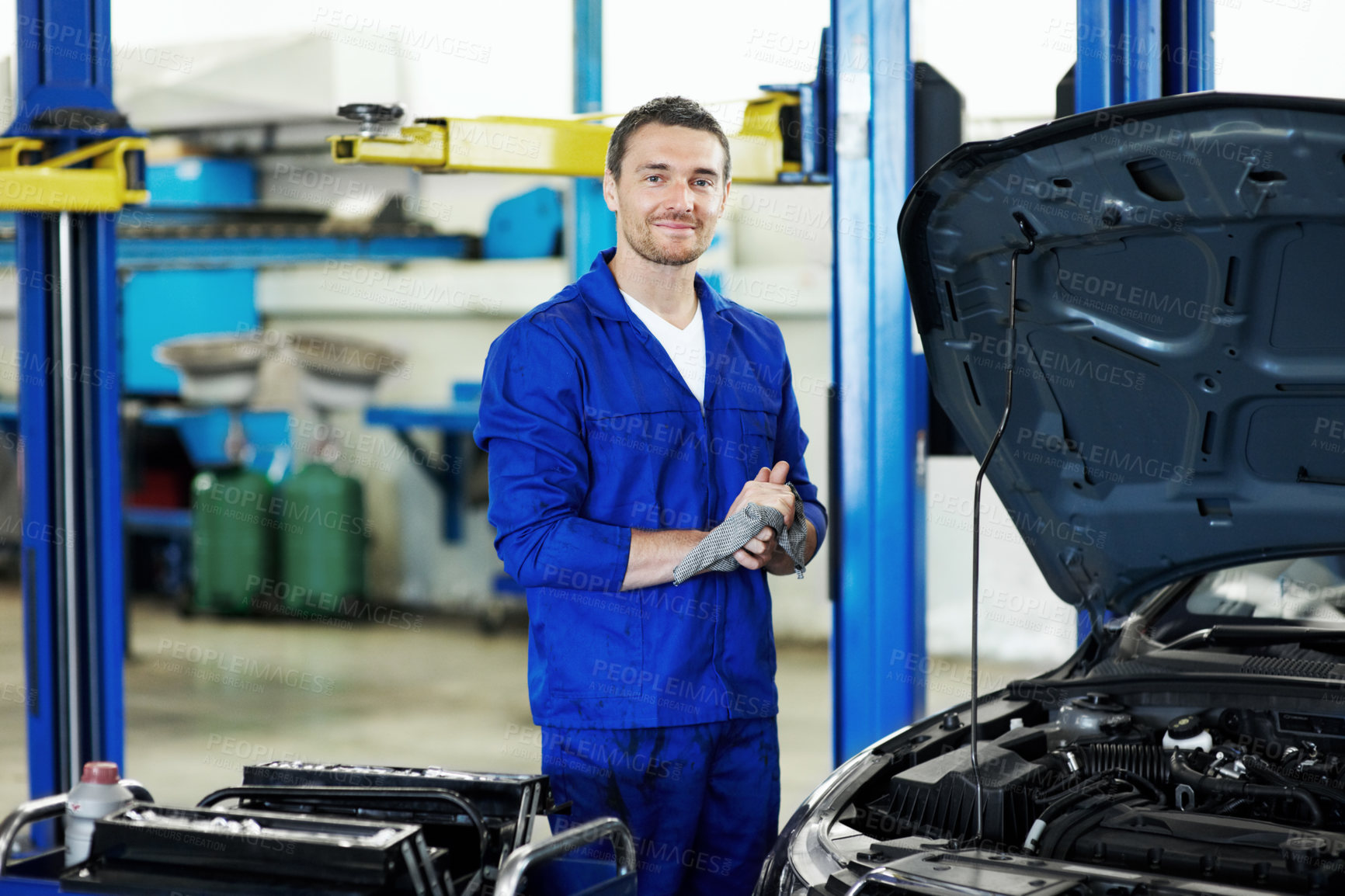 Buy stock photo Engine, car and portrait with man in workshop for motor oil change, mechanic inspection and auto repair. Brake fluid check, transmission maintenance and transport diagnostics with person in garage