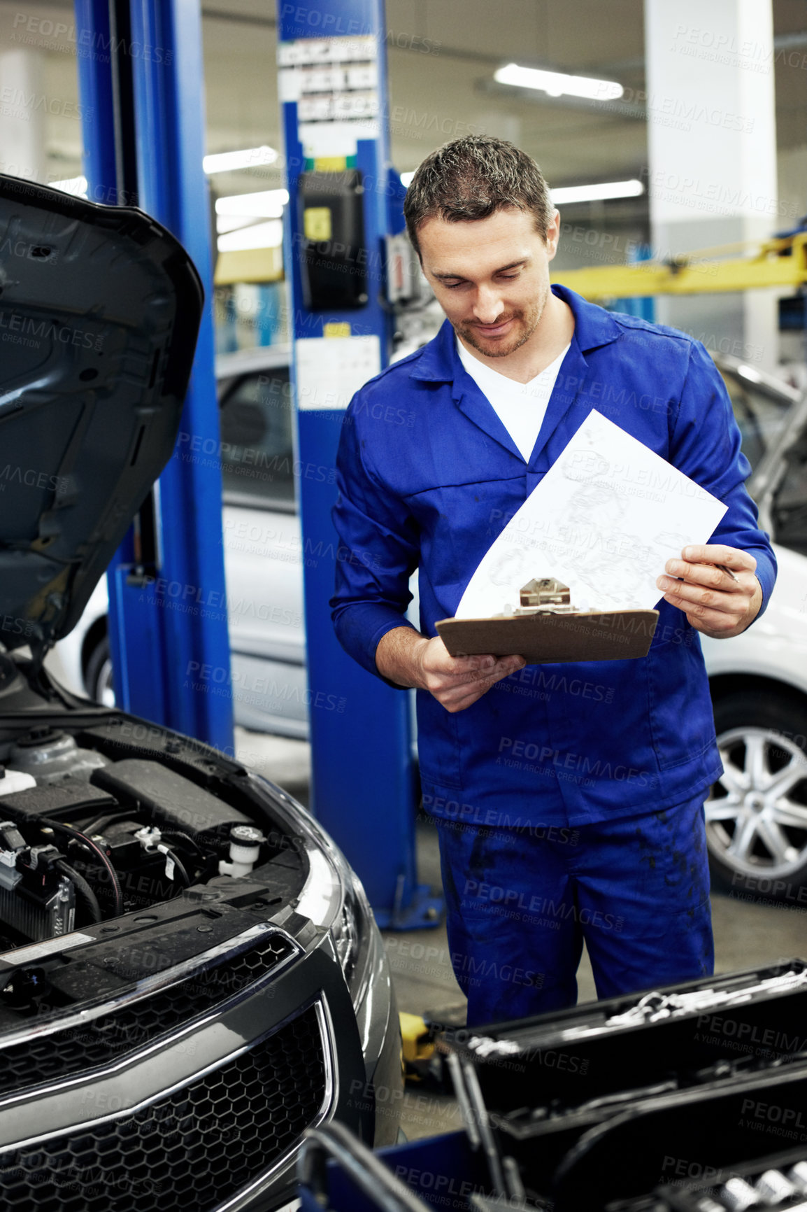 Buy stock photo Man, engineer and report with clipboard for car at workshop  for notes, invoice or repair services. Person, technician or mechanic with vehicle, checklist and maintenance with career in auto garage