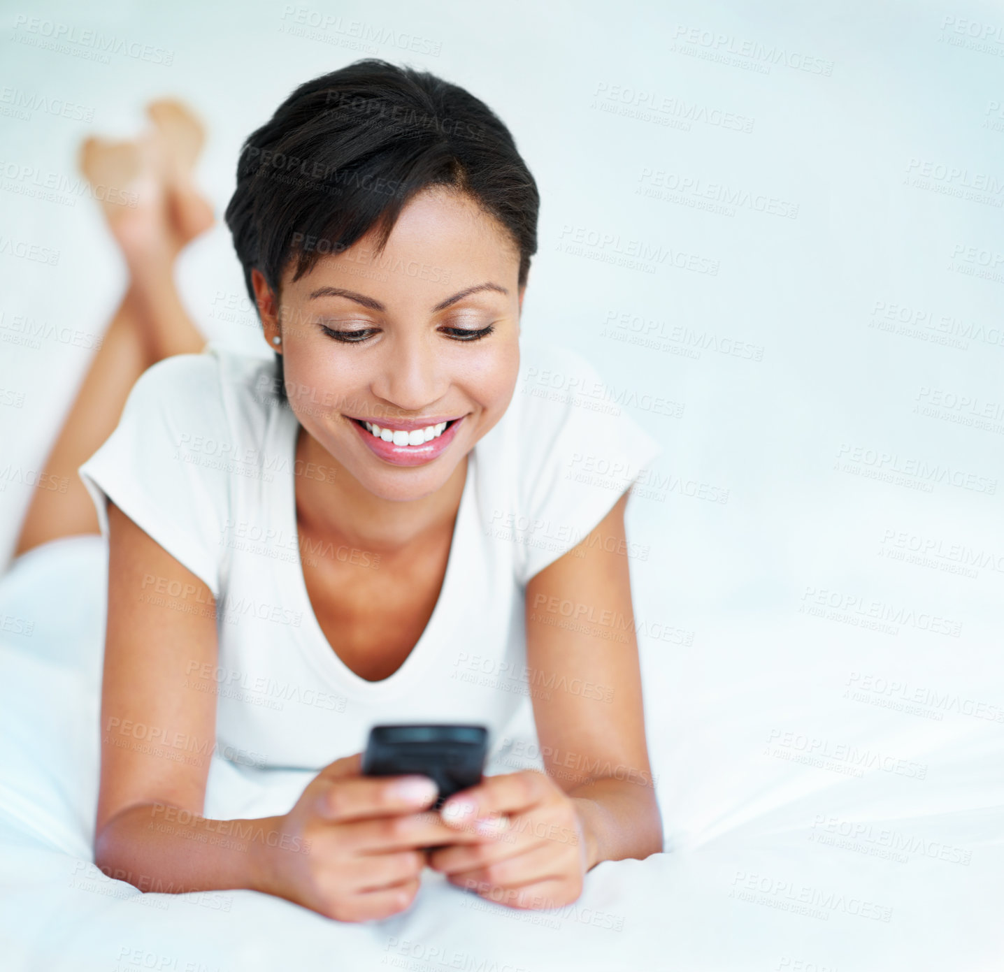 Buy stock photo Happy, woman and typing on bed with phone, social media and online dating app notification on weekend. Space, female person relax and smile in home with tech, text message and internet connectivity.