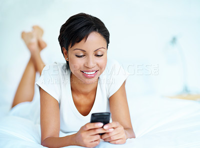 Buy stock photo Happy, woman and scroll on bed with phone, social media and online dating app notification on weekend. Space, female person relax and smile in home with tech, text message and internet connectivity.