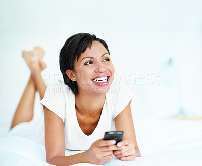 Buy stock photo Phone, smile and thinking with woman on bed in home for inspiration, nostalgia or reflection. App, social media and space with happy person in bedroom of apartment for ideas, me time or relax