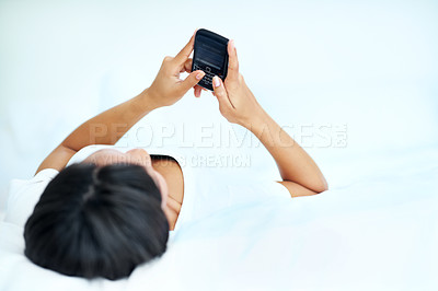 Buy stock photo Woman, relax and typing in bedroom with phone, social media or online dating notification on weekend. Space, female person rest and browsing in home with tech, text message and internet connectivity.