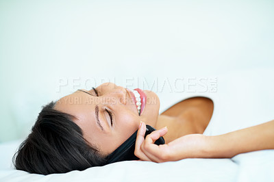Buy stock photo Happy, woman and relax in bedroom with phone call, hearing story and gossip update on weekend break. Space, female person rest and listen to feedback with tech, contact and connectivity in home.