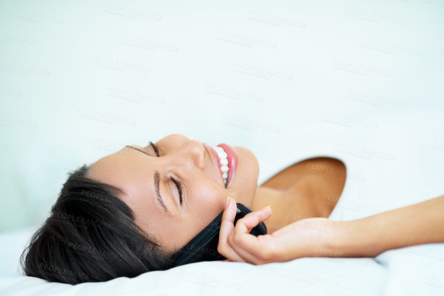 Buy stock photo Happy, woman and relax in bedroom with phone call, hearing story and gossip update on weekend break. Space, female person rest and listen to feedback with tech, contact and connectivity in home.