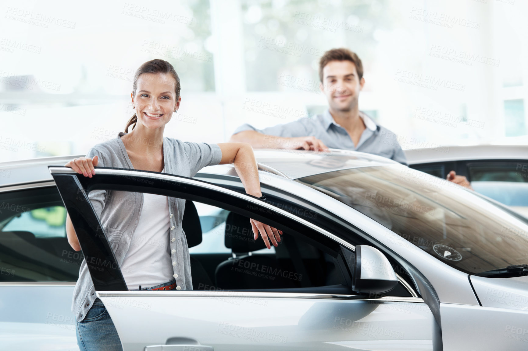 Buy stock photo Portrait, woman and couple at dealership with car, inspection and transport for test drive. Smile, people and satisfaction in showroom with vehicle, finance approval and collection of auto purchase

