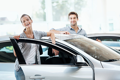 Buy stock photo Laugh, couple and shopping at car dealership, portrait and buyer with partner for new automobile. Showroom, man and funny woman by vehicle door for purchase, rental and customers with transport