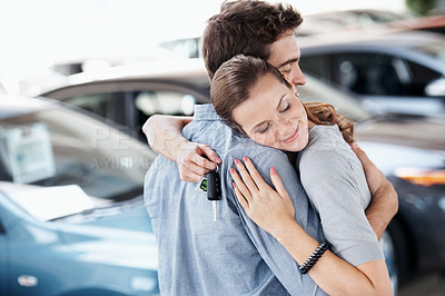 Buy stock photo Couple, hug and smile with keys, new car and love for dealership purchase and celebration. Loan approval, showroom and people shopping for motor rental, embrace and investment for transportation