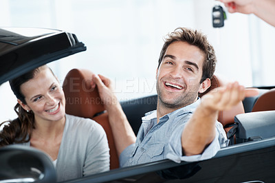 Buy stock photo Couple, excited and smile with keys, car dealership and appointment for purchase and celebration. Loan approval, showroom and people shopping for vehicle, rental or investment for transportation