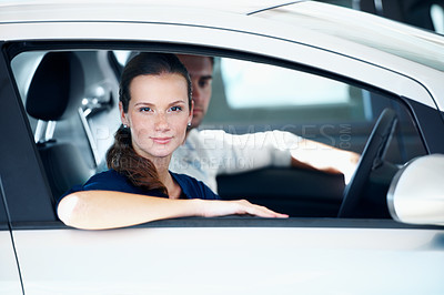 Buy stock photo Dealership, portrait and retail with woman in car  for automobile choice, purchase or test drive. Sale, serious and window with customer couple in showroom together for decision or vehicle finance
