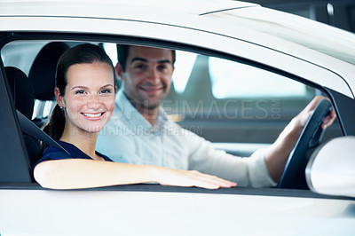 Buy stock photo Dealership, sale and smile of woman in car for automobile choice, purchase or test drive. Portrait, retail and window with customer couple in showroom together for decision or vehicle finance