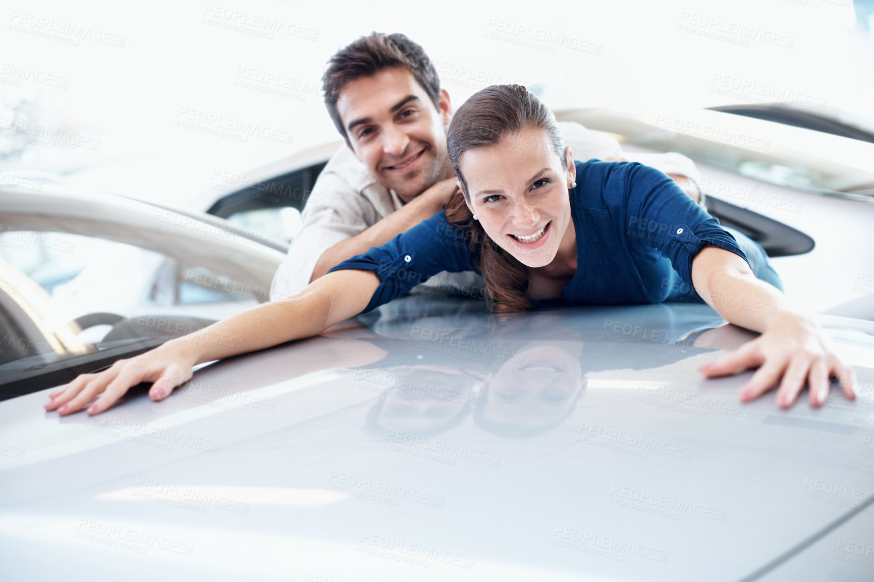 Buy stock photo Couple, portrait and excited at car dealership by bonnet for purchase, buying and choice of vehicle. Man, woman and smile by space for milestone, luxury or showroom for customer or client achievement
