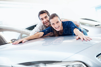 Buy stock photo Couple, portrait and happy at car dealership by bonnet for purchase, buying and choice of vehicle. Man, woman and laugh by space for milestone, luxury or showroom for customer or client achievement