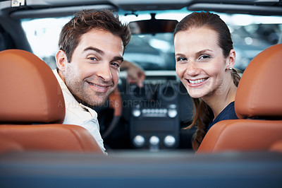 Buy stock photo Car dealership, couple and portrait in convertible for decision, purchase or test drive. Back, satisfaction and smile with happy people in showroom vehicle for consumerism, insurance or finance