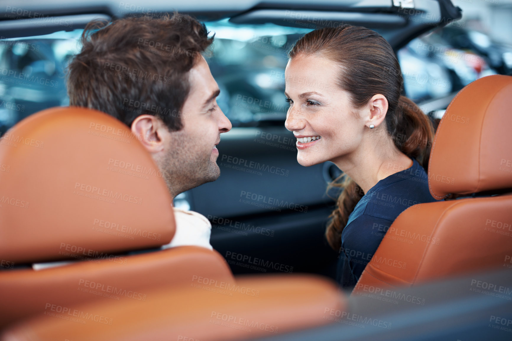 Buy stock photo Back, car dealership and happy couple in convertible for decision, purchase or test drive. Choice, love and satisfaction with people in showroom vehicle for consumerism, insurance or finance