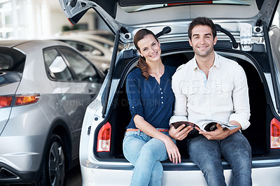 Buy stock photo Couple, portrait and happy at car dealership with brochure for purchase, buying and choice of vehicle. Man, woman and smile by trunk for catalog, insurance or showroom for customer or client