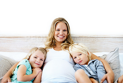 Buy stock photo Portrait of a pregnant mother with her little son and daughter sitting together at home