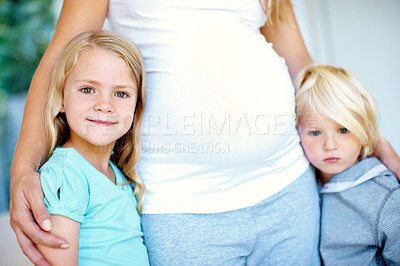 Buy stock photo Portraitof a little girl and boy with their pregnant mother's belly