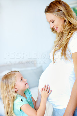 Buy stock photo Cropped image of a little girl holding her mother's pregnant belly