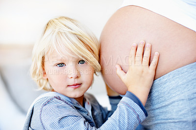 Buy stock photo Portrait of a little boy with his arms around his mother's pregnant belly