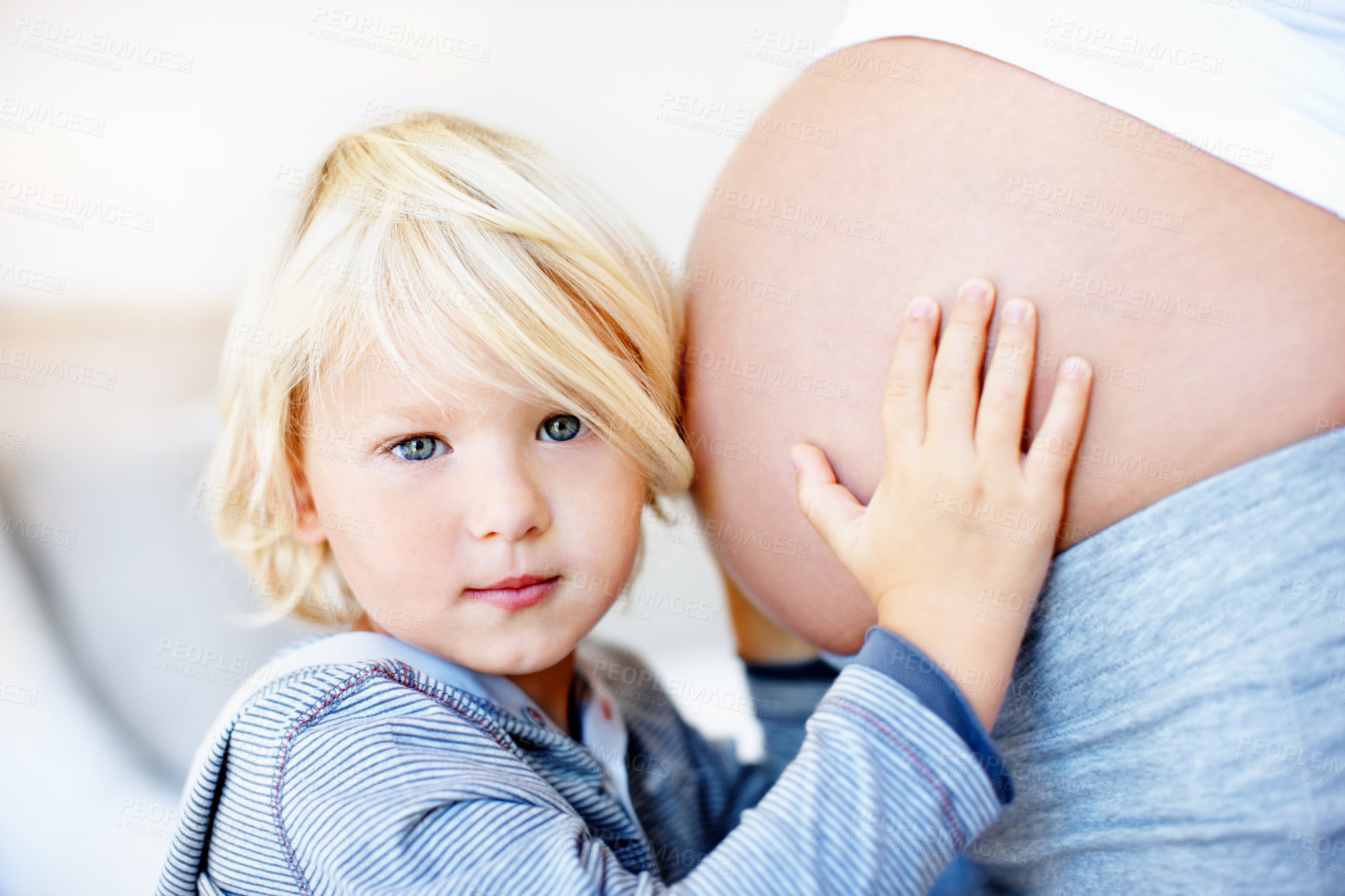Buy stock photo Pregnant, mom and child listen to stomach in home for baby kick, sibling bonding and anticipation. Mother, pregnancy and kid portrait with ear on belly for curiosity, family growth and prenatal care