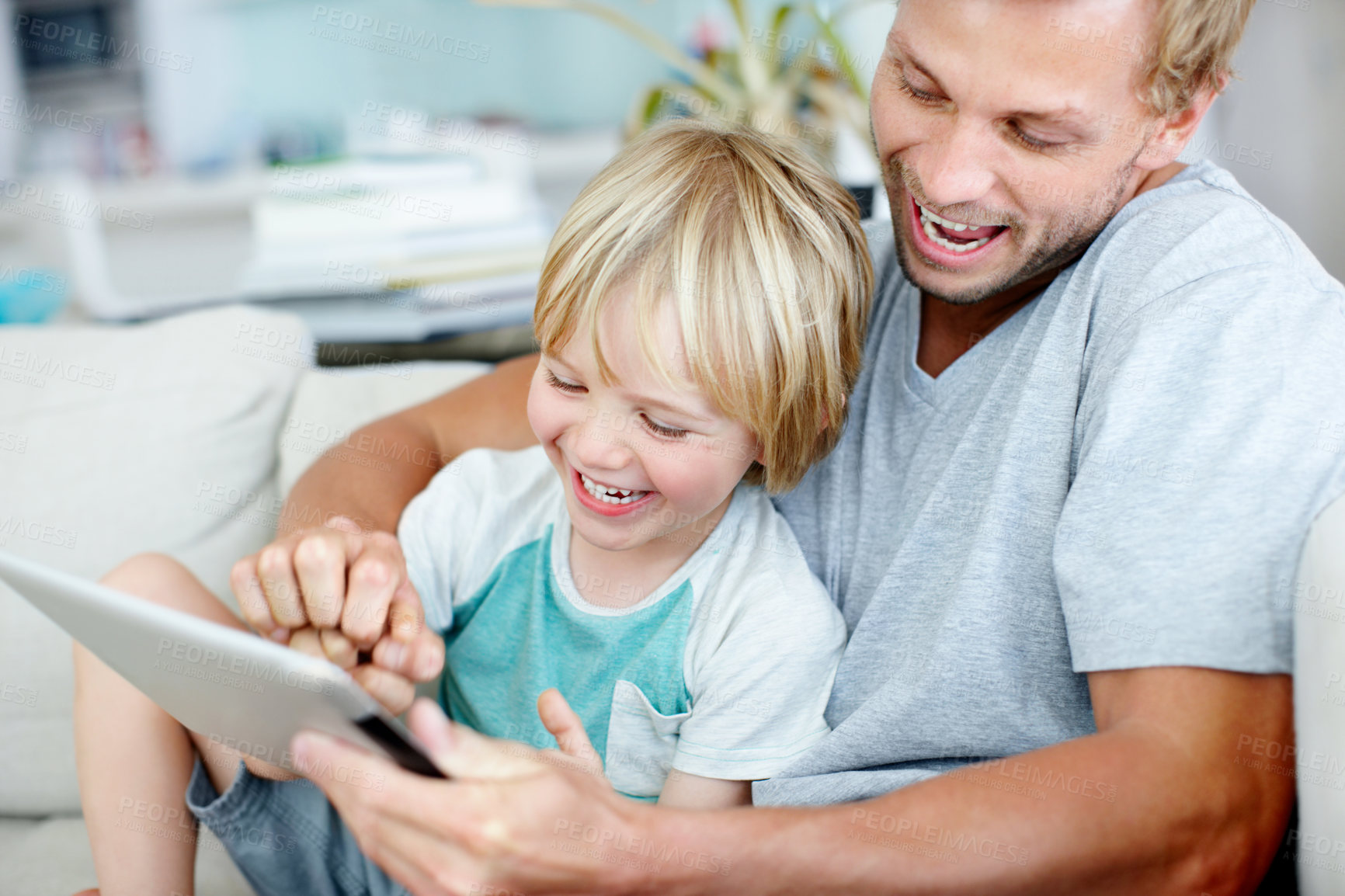 Buy stock photo Tablet, funny and father with son on sofa in family home for education app, smile or learning game. Laughing, child development website and subscription with man and kid in living room for bonding