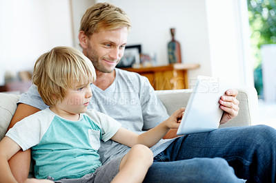 Buy stock photo Loving father and son on the couch using their digital tablet together