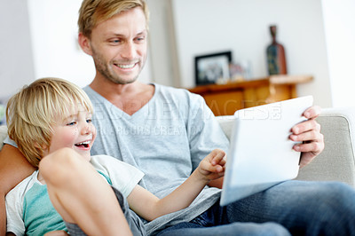 Buy stock photo Loving father and son on the couch using their digital tablet together