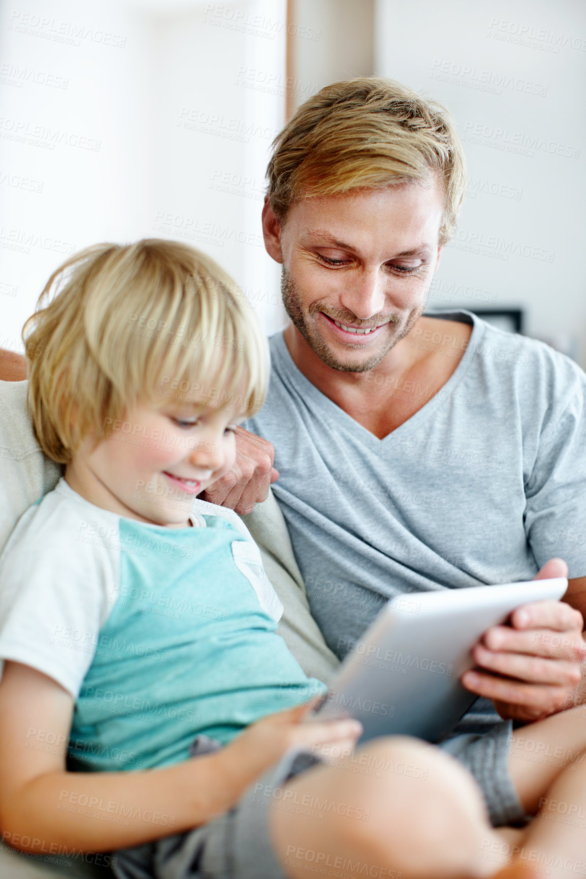 Buy stock photo Tablet, relax and reading with father and son on sofa for streaming service, bonding and movie subscription. Online film, happy and multimedia search with man and child in living room of family home