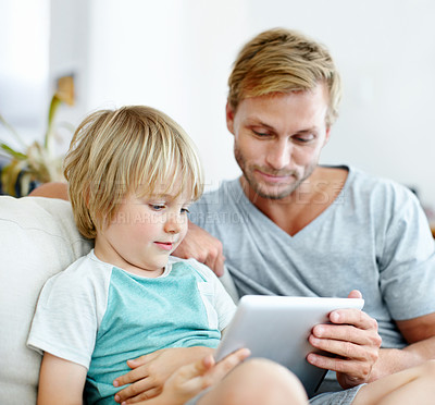 Buy stock photo Loving father and son on the couch using their digital tablet together