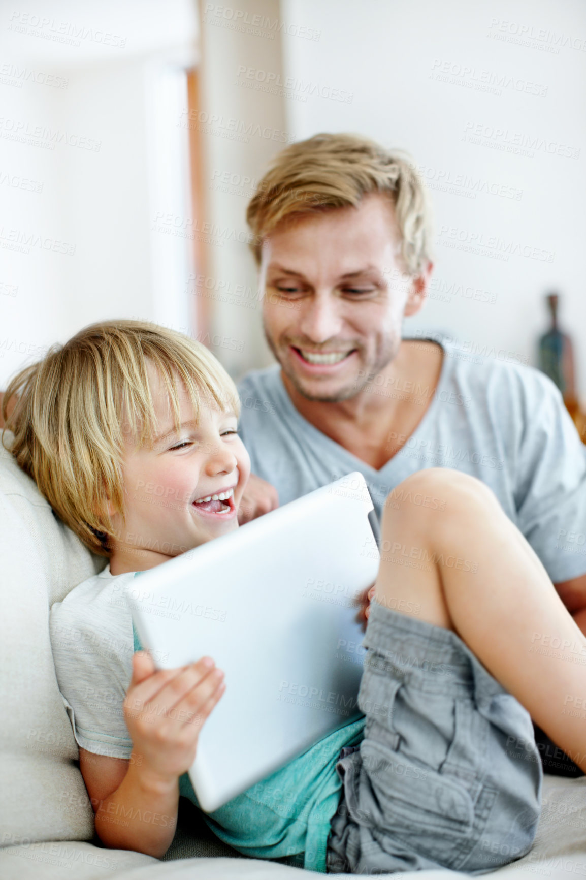 Buy stock photo Tablet, love and laughing with father and son on sofa for streaming service, bonding and movie subscription. Online film, happy and multimedia search with man and child in living room of family home
