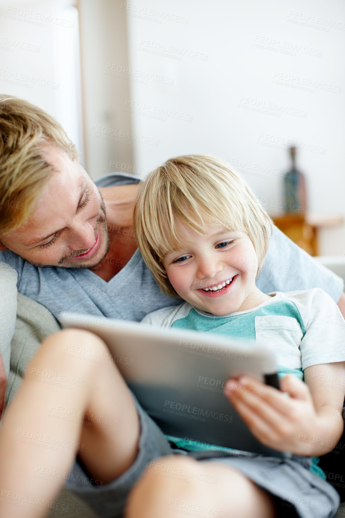 Buy stock photo Tablet, watch and laughing with father and son on sofa for streaming service, bonding and movie subscription. Online film, love and multimedia search with man and child in living room of family home