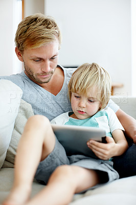 Buy stock photo Loving father and son on the couch using their digital tablet together