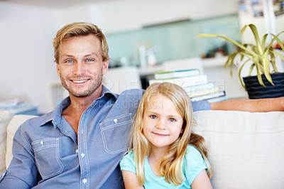 Buy stock photo Cute little girl sitting on the sofa with her dad while at home
