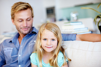 Buy stock photo Cute little girl sitting on the sofa with her dad while at home