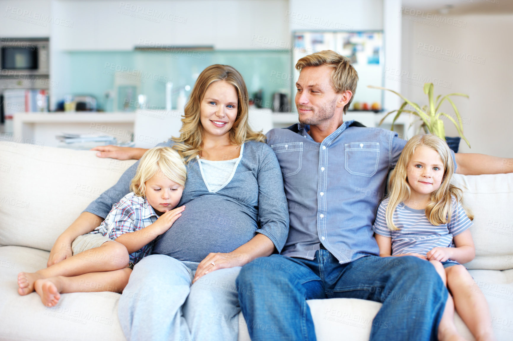 Buy stock photo Pregnant, family and kids with parents on sofa in home for childhood, growth or sibling. Maternity, mom and dad with children, hug or happy for parenthood, care or love together on couch in house