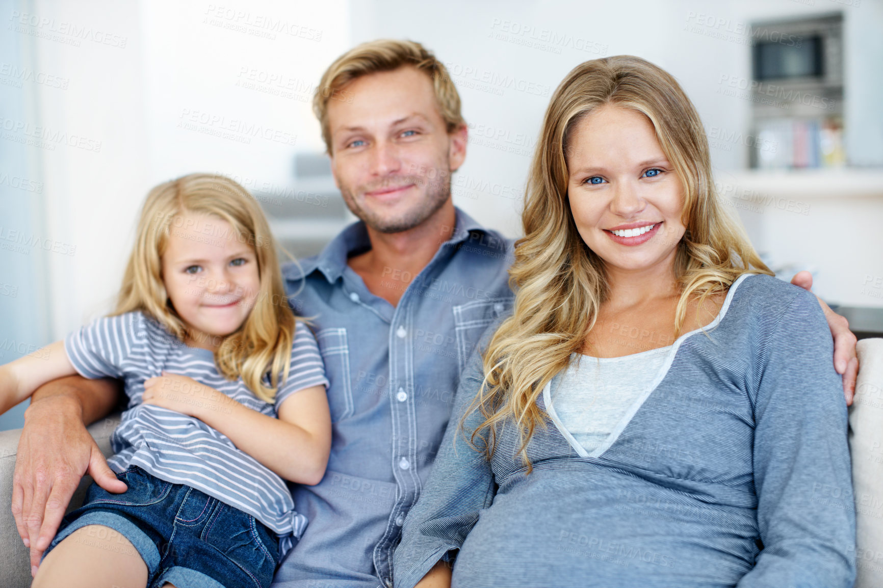 Buy stock photo Portrait, pregnancy and support with family on sofa in home living room together for bonding or security. Break, development and happy girl child in apartment with parents for growth or wellness