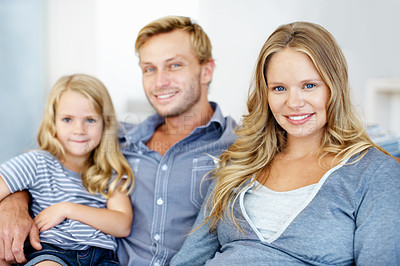 Buy stock photo Cute little girl sitting on the sofa with her father and mother