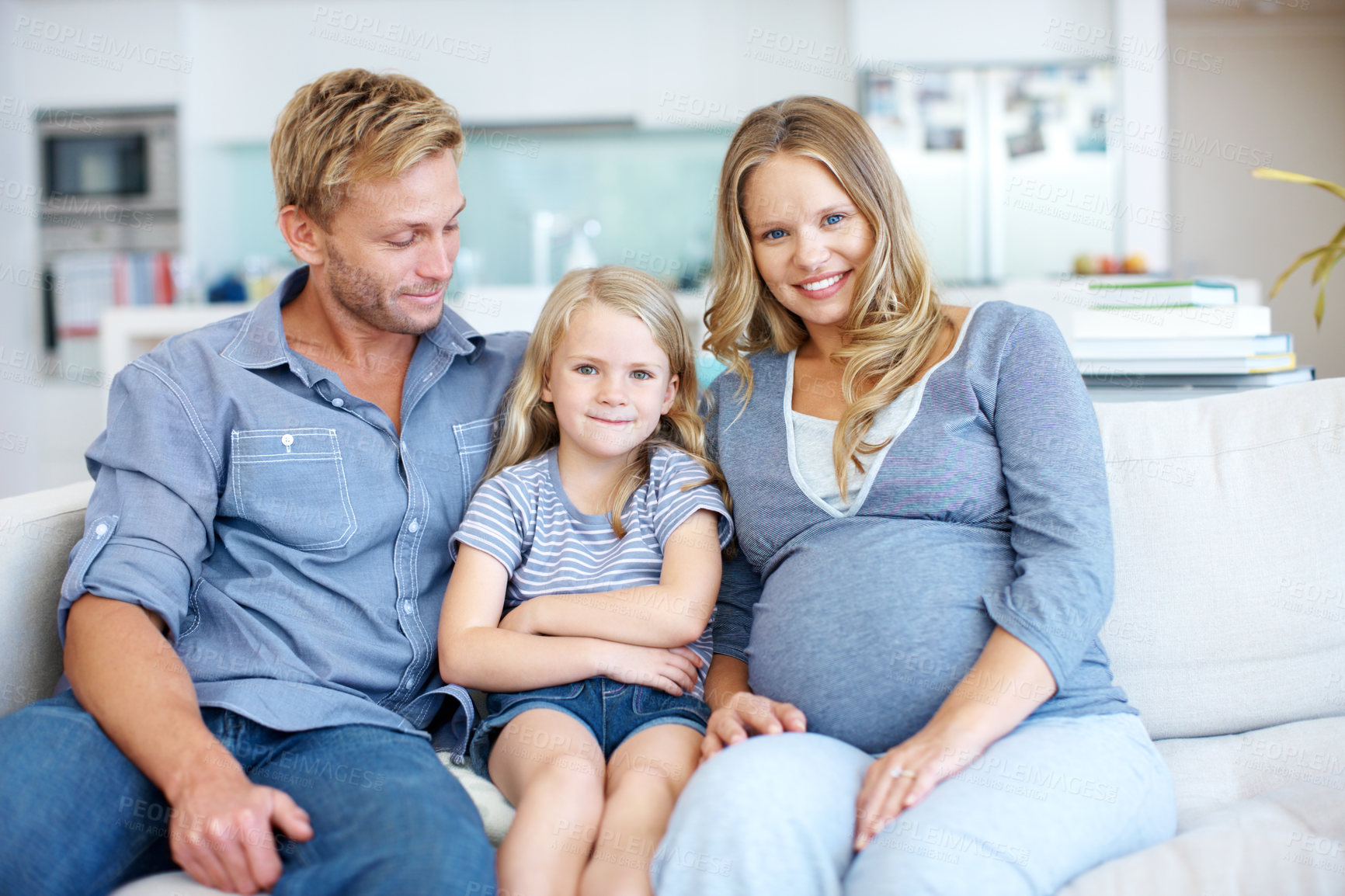 Buy stock photo Pregnancy, support and smile with family on sofa in home living room together for bonding or security. Development, love and portrait of happy daughter in apartment with parents for break or growth