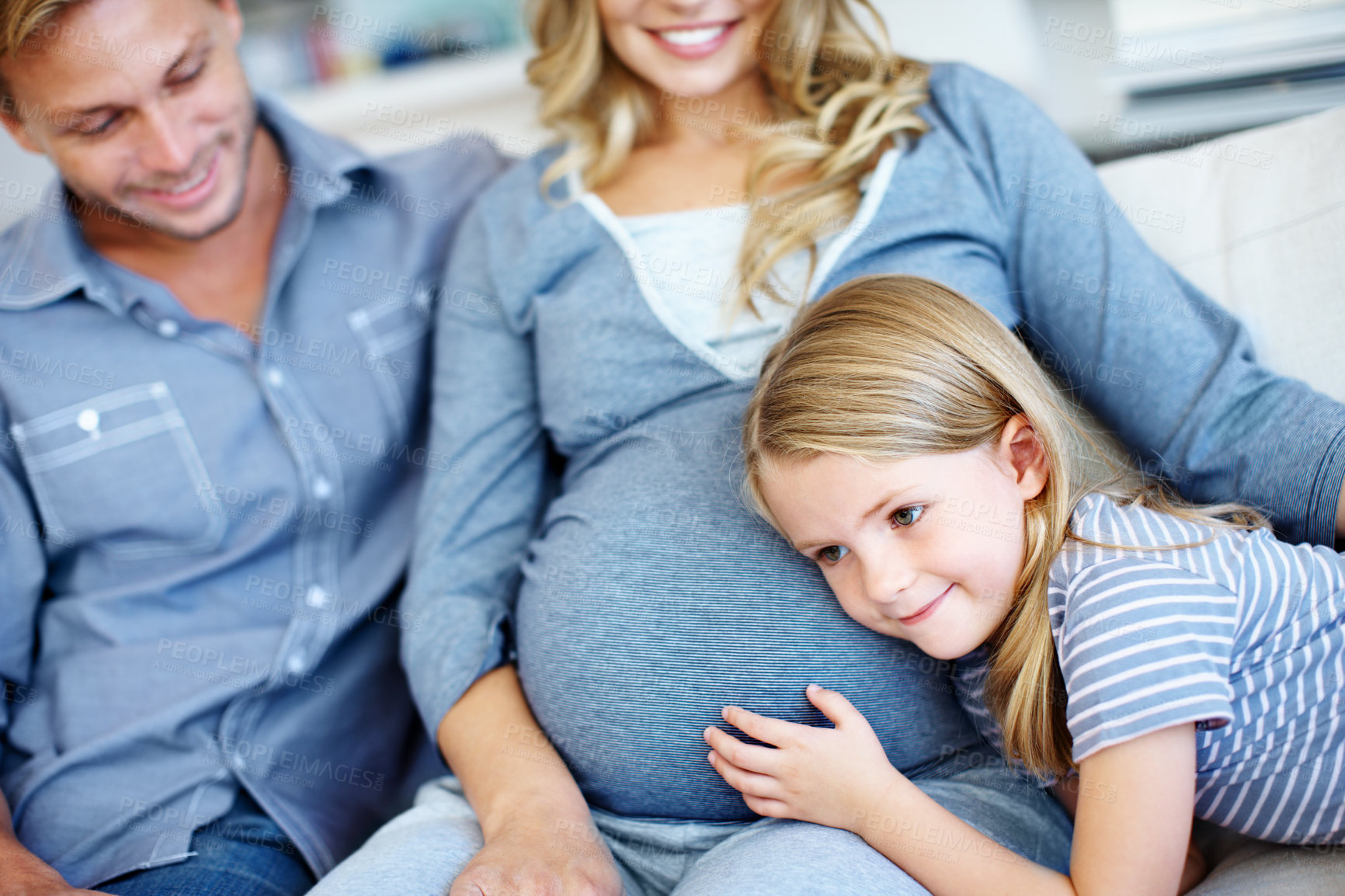Buy stock photo Daughter, listening and pregnant mother on sofa with dad in home living room for bonding or love. Belly, curiosity and pregnancy with happy family in apartment together for growth or security