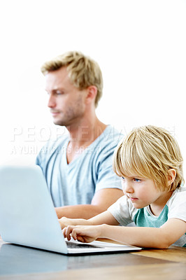 Buy stock photo A young father and his little boy working on their laptops togther