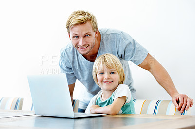 Buy stock photo Portrait of a young father and his little boy working on a laptop together