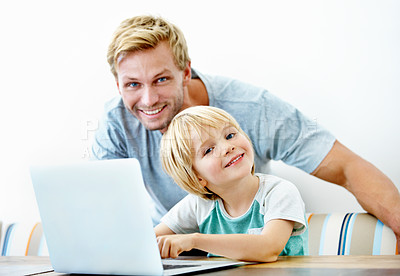 Buy stock photo Portrait of a young father and his little boy working on a laptop together
