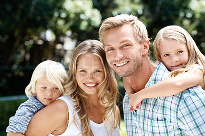 Buy stock photo A happy family of four smiling while outside in a garden - Portrait
