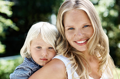 Buy stock photo Pretty young mother in the summer sunshine outdoors with her little boy