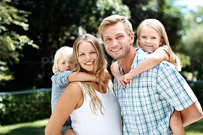Buy stock photo A happy family of four smiling while outside in a garden - Portrait