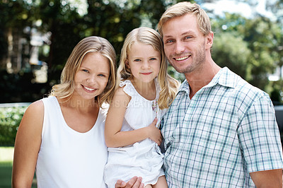 Buy stock photo A happy family of three smiling while outside in a garden - Portrait