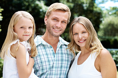 Buy stock photo A happy family of three smiling while outside in a garden - Portrait